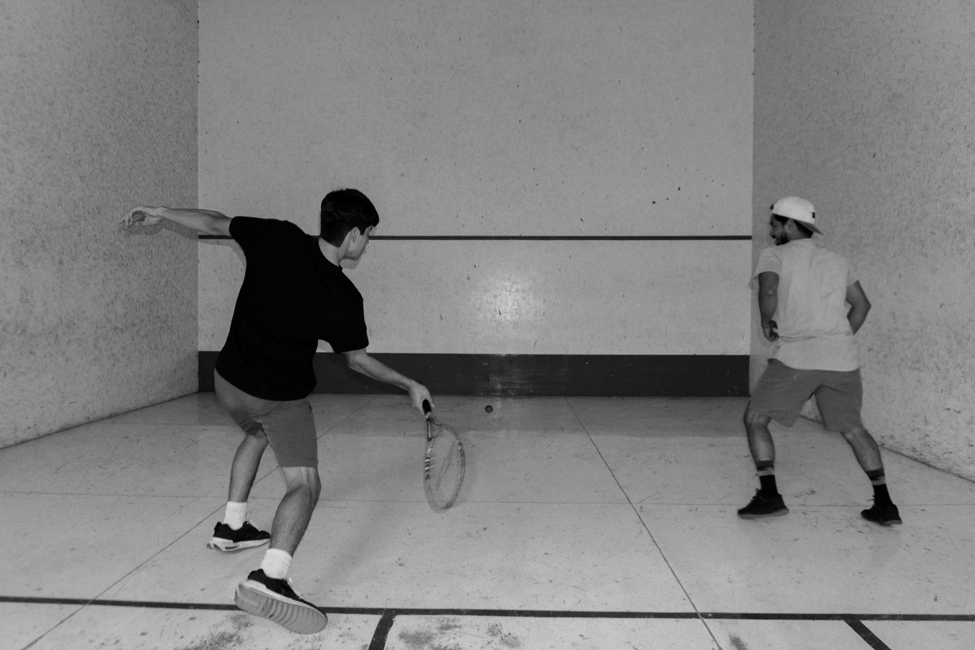Two players on a squash court